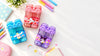 Twin compartment cartoon bottle for kids in blue, pink and purple with colourful school supplies